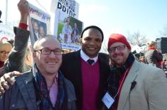 My husband, Sean and I standing with Brendon Ayanbadejo outside the Supreme Court in March
